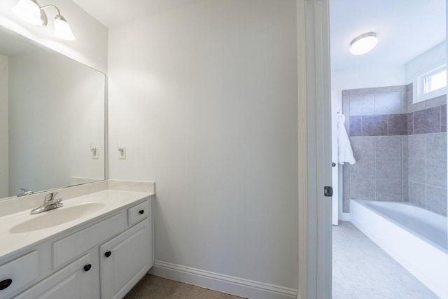 full bath featuring vanity, baseboards, and tile patterned flooring