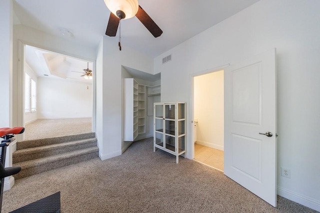 unfurnished bedroom featuring visible vents, carpet floors, baseboards, and a ceiling fan