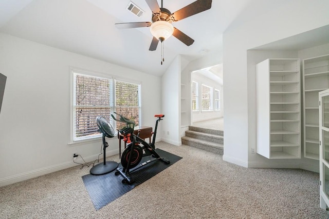 workout area featuring visible vents, carpet, a healthy amount of sunlight, and vaulted ceiling