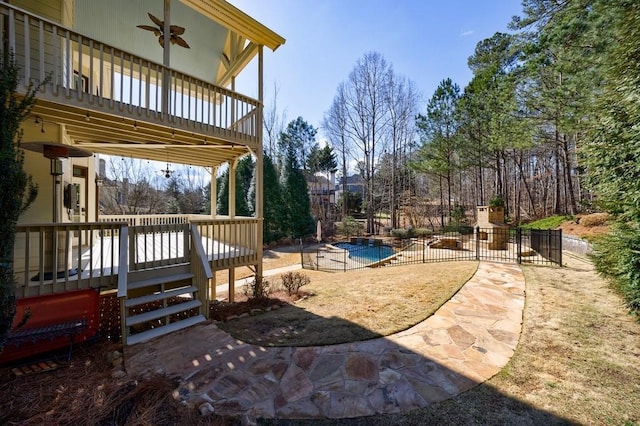 view of yard featuring a fenced in pool, a patio, ceiling fan, and a deck