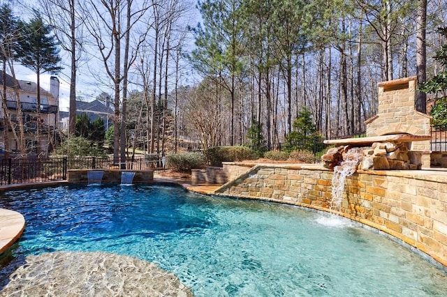 view of swimming pool with a fenced in pool and fence