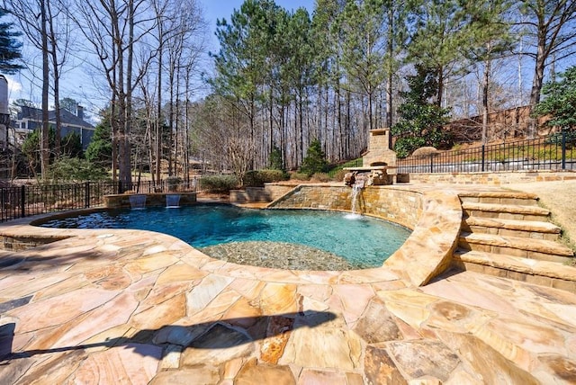 view of swimming pool featuring a patio area, a fenced in pool, an outdoor fireplace, and fence