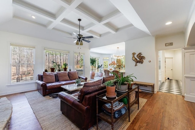 living room with coffered ceiling, recessed lighting, beamed ceiling, ceiling fan with notable chandelier, and light wood-type flooring