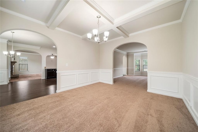212 Jetta Cir, Mcdonough, GA 30253 - carpeted spare room featuring arched walkways, a chandelier, beamed ceiling, crown molding, and wood finished floors