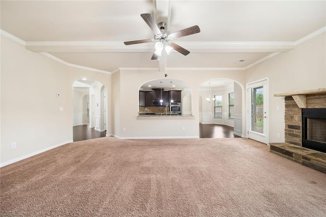212 Jetta Cir, Mcdonough, GA 30253 - unfurnished living room featuring arched walkways, carpet, ceiling fan, ornamental molding, and beam ceiling