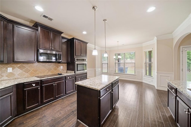 212 Jetta Cir, Mcdonough, GA 30253 - kitchen with stainless steel appliances, arched walkways, dark brown cabinetry, a decorative wall, and crown molding