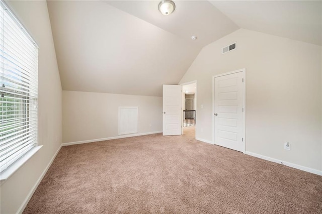212 Jetta Cir, Mcdonough, GA 30253 - additional living space with vaulted ceiling, light carpet, and baseboards