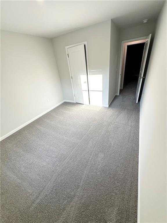 321 Lambert Overlook Cir, Carrollton, GA 30117 - spare room featuring baseboards and carpet floors