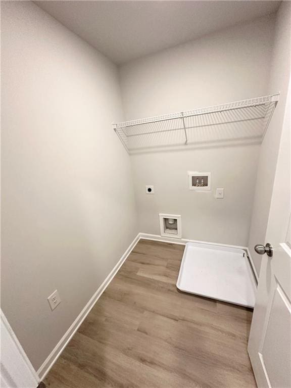321 Lambert Overlook Cir, Carrollton, GA 30117 - washroom with hookup for an electric dryer, baseboards, wood finished floors, and hookup for a washing machine