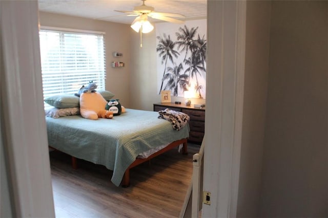 bedroom with hardwood / wood-style flooring and ceiling fan