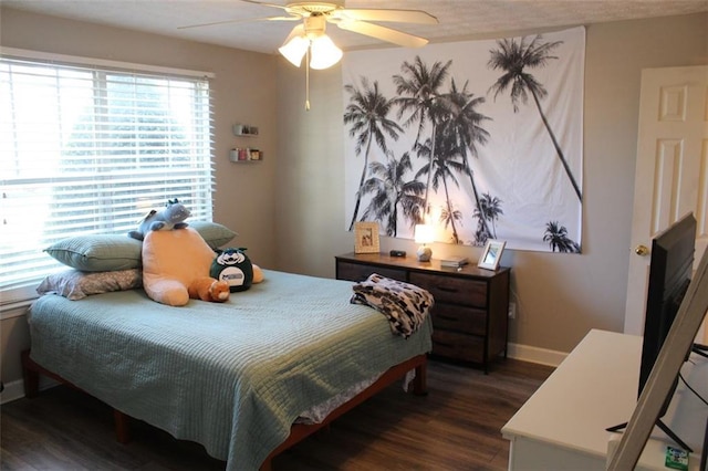 bedroom with ceiling fan and dark hardwood / wood-style floors