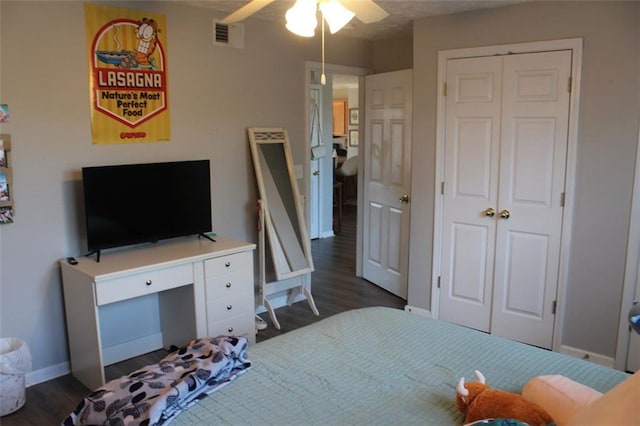 bedroom with ceiling fan, dark hardwood / wood-style flooring, and a closet