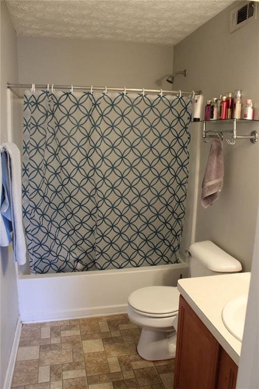 full bathroom with vanity, shower / tub combo, toilet, and a textured ceiling