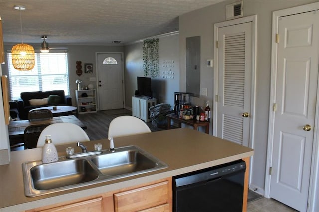 kitchen featuring sink, decorative light fixtures, a textured ceiling, light brown cabinets, and dishwasher