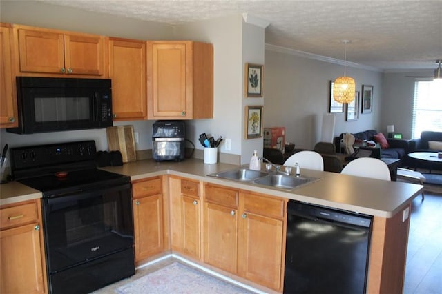 kitchen with sink, a textured ceiling, ornamental molding, kitchen peninsula, and black appliances