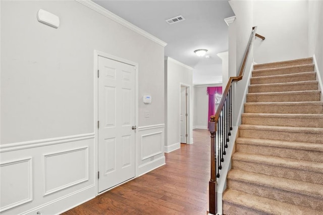 6535 Crosscreek Ln, Flowery Branch, GA 30542 - entrance foyer featuring stairway, wood finished floors, and crown molding