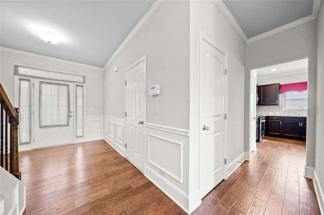 6535 Crosscreek Ln, Flowery Branch, GA 30542 - foyer featuring hardwood / wood-style floors, ornamental molding, stairs, and wainscoting