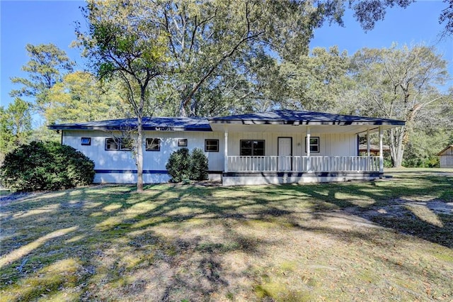 ranch-style home with a porch and a front lawn