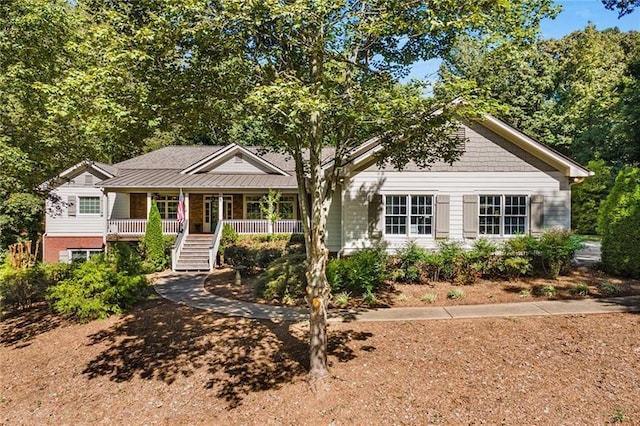 view of front of property with stairs and a porch