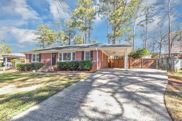 ranch-style home featuring a front lawn and a carport