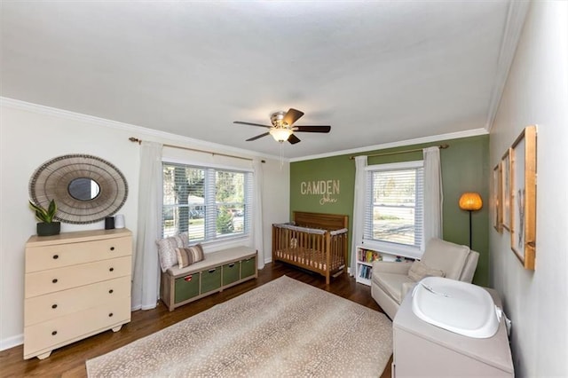 bedroom featuring multiple windows, crown molding, dark hardwood / wood-style flooring, and ceiling fan