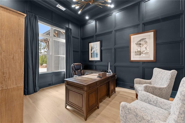 office space with a decorative wall, a healthy amount of sunlight, and visible vents