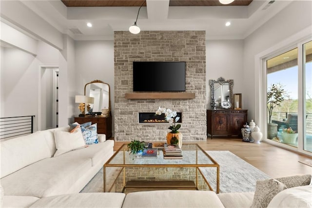 living room with recessed lighting, wood finished floors, visible vents, and a large fireplace