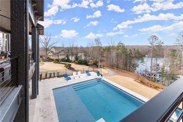 view of swimming pool with a fenced in pool, a water view, a patio, and fence