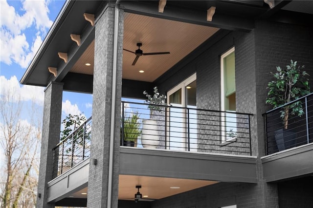 exterior space featuring brick siding and ceiling fan