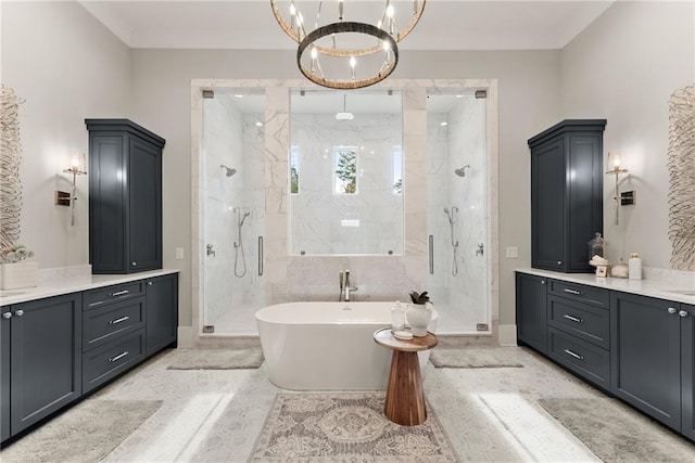 full bath with vanity, baseboards, a marble finish shower, a soaking tub, and a chandelier