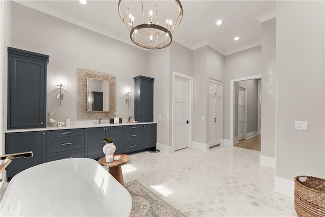 bathroom featuring crown molding, baseboards, a chandelier, a freestanding bath, and recessed lighting