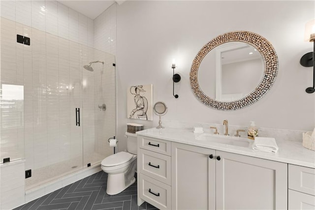 bathroom featuring tile patterned flooring, a stall shower, toilet, and vanity