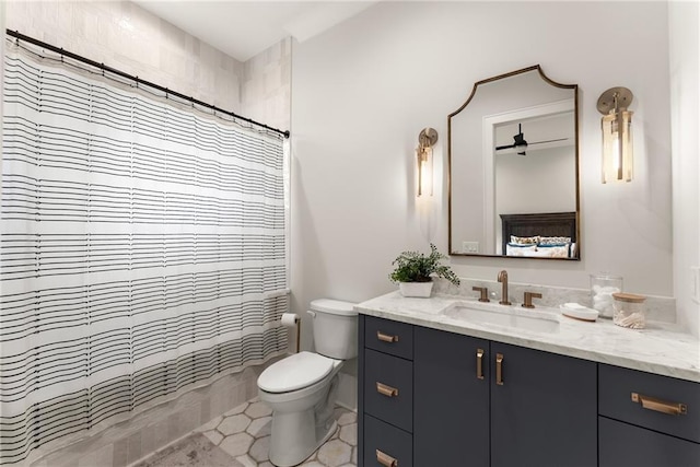 full bath featuring a shower with shower curtain, toilet, vanity, and tile patterned flooring