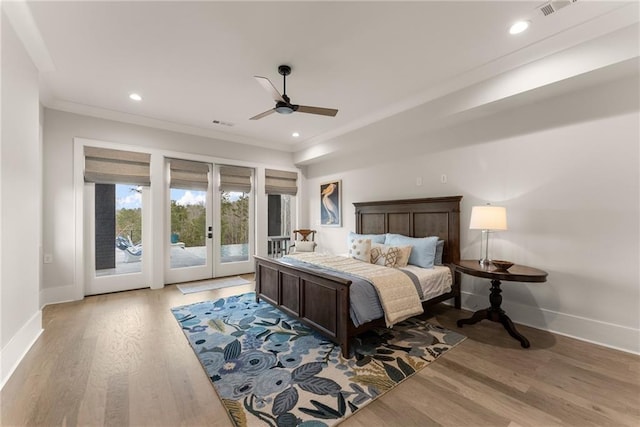 bedroom with access to exterior, french doors, baseboards, and wood finished floors