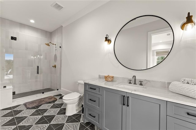 bathroom featuring visible vents, toilet, a shower stall, tile patterned flooring, and vanity