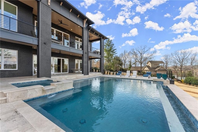 view of swimming pool with a fenced in pool, a patio, an in ground hot tub, and ceiling fan