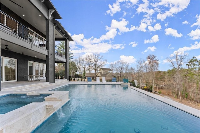 view of swimming pool featuring french doors, a pool with connected hot tub, and a patio