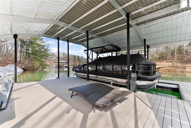 dock area featuring boat lift and a water view