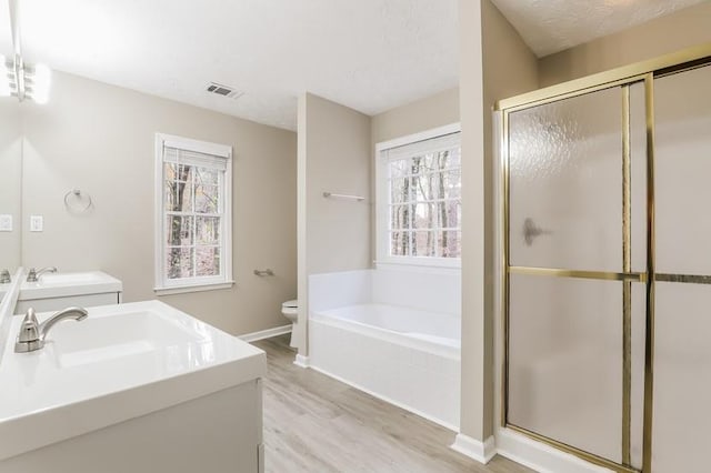 full bathroom featuring hardwood / wood-style flooring, vanity, toilet, and independent shower and bath