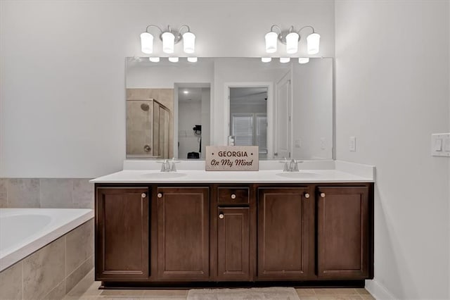 bathroom featuring vanity and shower with separate bathtub