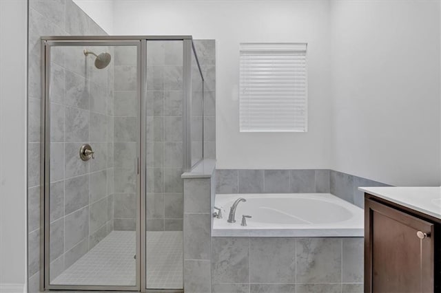 bathroom featuring vanity and separate shower and tub