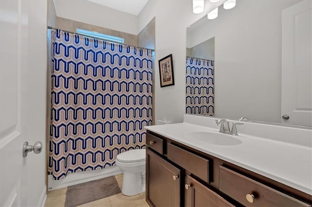 bathroom with vanity, tile patterned flooring, and toilet