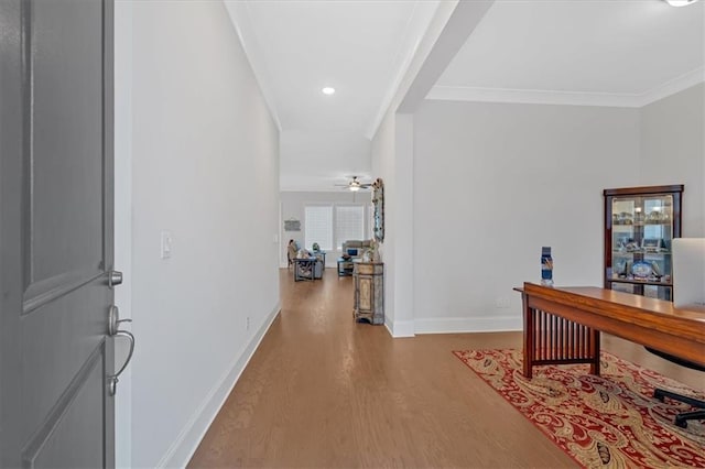 hallway featuring ornamental molding and light hardwood / wood-style floors