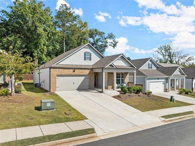 view of front facade with a garage, fence, a front lawn, and concrete driveway