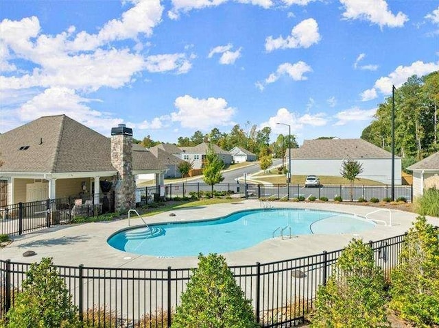 pool featuring a patio and fence