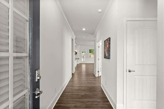 corridor featuring baseboards, dark wood-style flooring, and crown molding