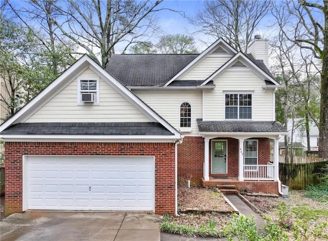 traditional-style home with brick siding, a chimney, a porch, a garage, and driveway