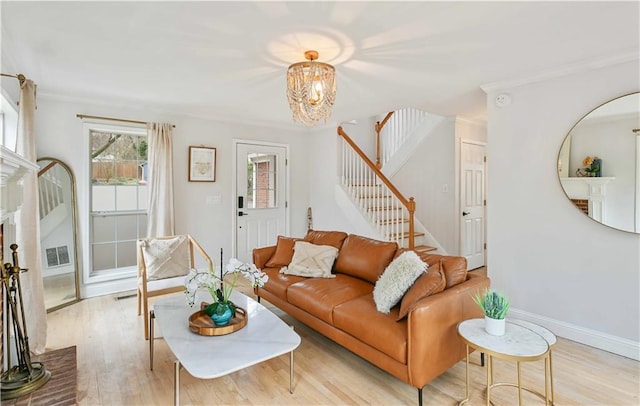 living room with baseboards, visible vents, stairway, crown molding, and light wood-type flooring