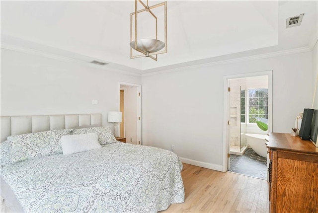 bedroom with baseboards, light wood finished floors, visible vents, and crown molding