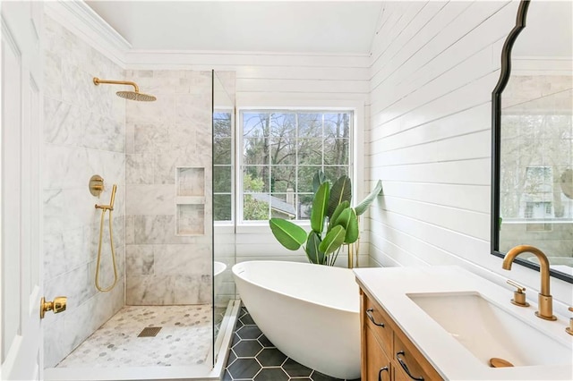 bathroom with a tile shower, vanity, and a freestanding bath